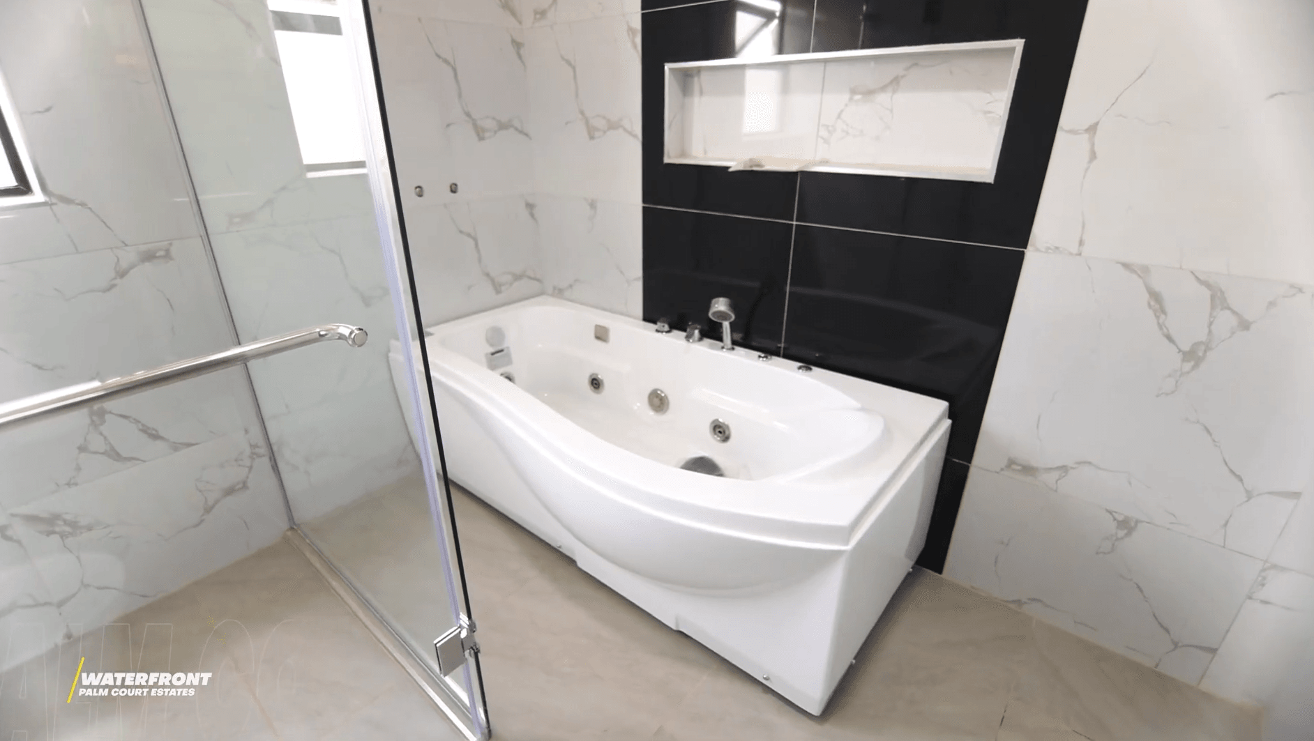 Master bathroom with jacuzzi tub and marble wall tiles