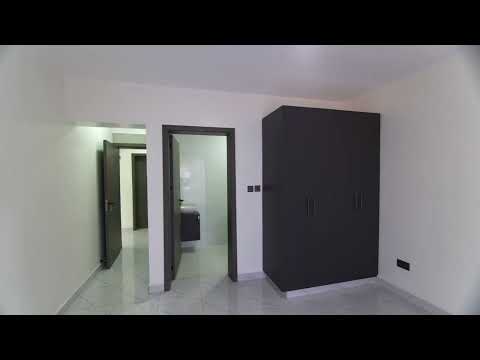 Guest bedroom with built-in dark wardrobes