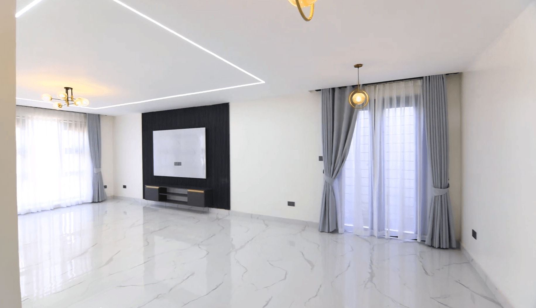 Contemporary living room with LED feature ceiling and large windows